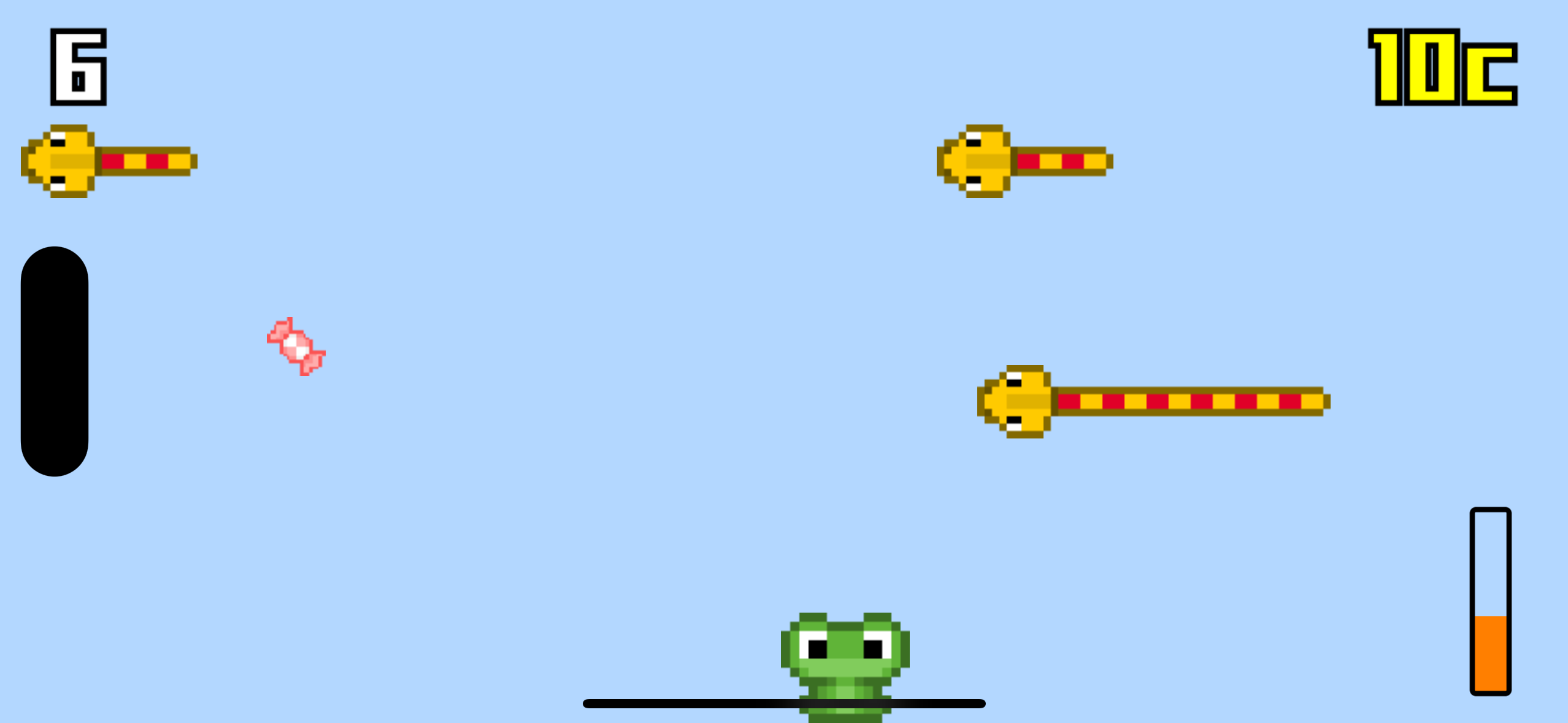 A frog sits on the bottom of the screen near a pink candy. Snakes are moving from the right to the left side of the screen.